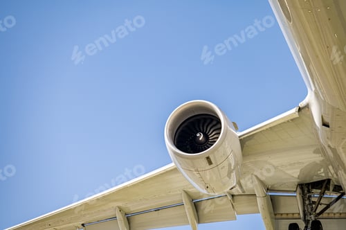 Preview: Closeup low angle shot of an airplane turbine in the sky