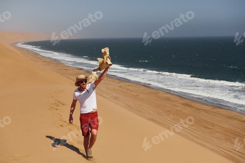 Preview: Tourist is walking on the sand near the sea