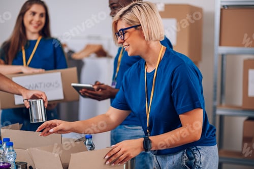Preview: Portrait of a woman volunteer working in a charity donation center