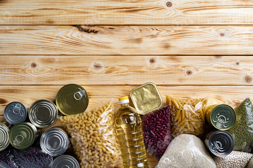 Preview: Donations food with canned food on the table background. Donate concept.