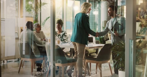 Preview: Handshake, meeting and partnership with business people in boardroom of glass office together. Deal