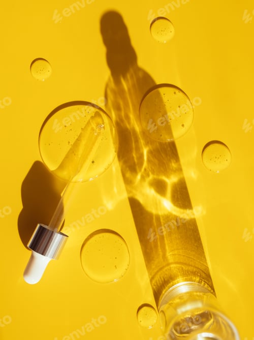 Preview: ipette drop of serum test on a yellow background