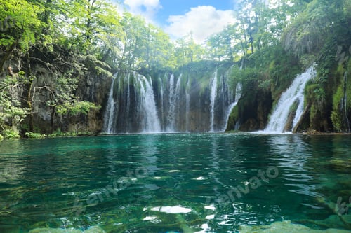 Preview: Picturesque view of beautiful waterfall and lake on sunny day