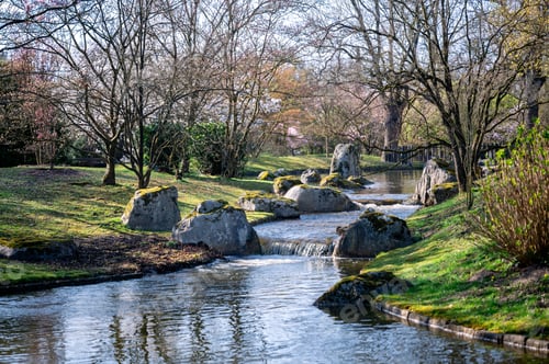 Preview: Serene flowing water. Peaceful waterway weaving through lush Japanese style garden landscape