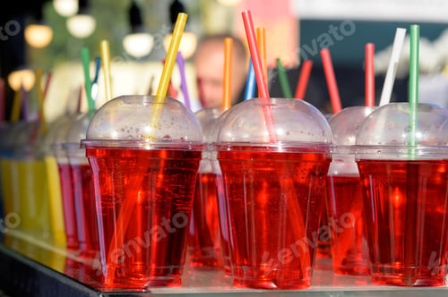 Preview: Different colors of cold water in a plastic cup.