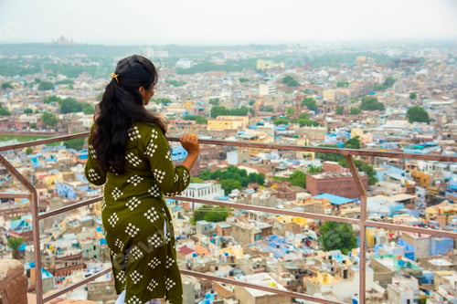 Preview: Portrait of Indian woman against view of Jodhpur the blue city in Rajasthan India