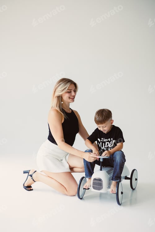 Preview: Playful Moments A Mother and Her Son Joyfully Engaging with a Colorful Toy Vehicle