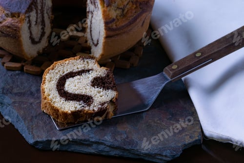 Preview: Closeup shot of a piece of delicious homemade marble pound cake on a baking spatula