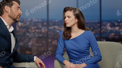 Preview: Two tv show people discussing global world problems in air studio close up.