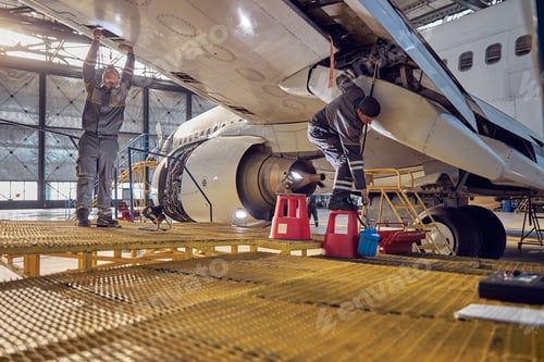 Preview: Technical aviation specialists fixing flight control surfaces