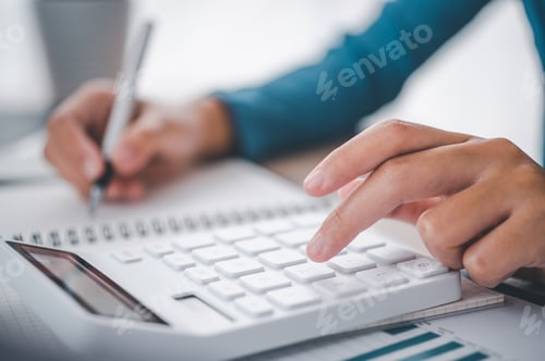 Preview: close up The business person is sitting on a calculator with a graph in the office