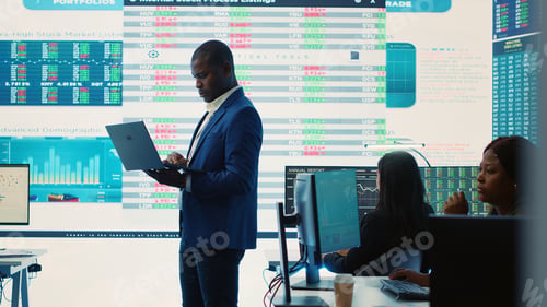 Preview: Chief financial officer studying capital funds and revenue data on big screen