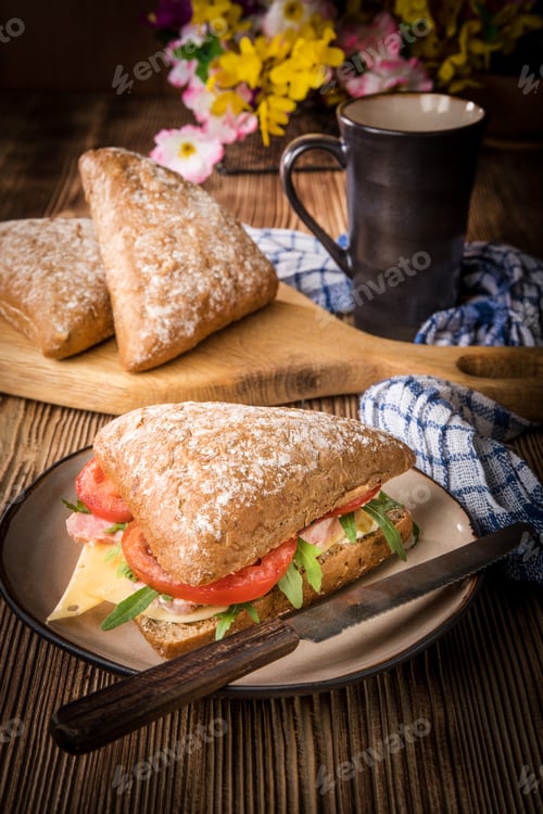 Preview: Triangular sandwich with cheese, ham and tomato.