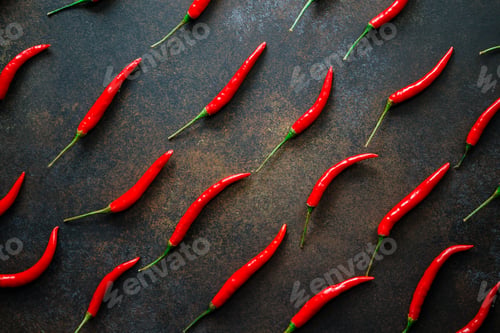 Preview: A lot of chili peppers on a kitchen table. Top view.