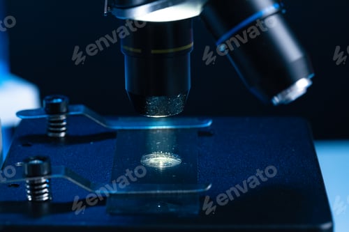 Preview: Microscope with lenses close up against dark background