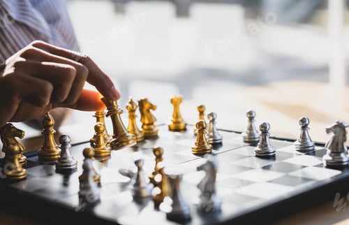 Preview: Businessman moving gold Chess King figure and Checkmate opponent during chessboard competition.