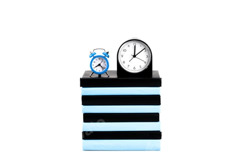 Preview: Clocks and stack of books isolated on white