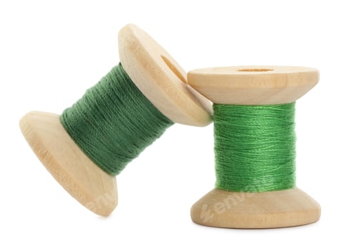 Preview: Different colorful sewing threads on white background, closeup
