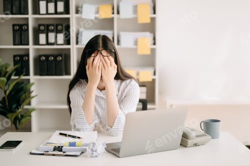 Preview: Asian business woman is stressed, bored, and overthinking from working on a tablet at the