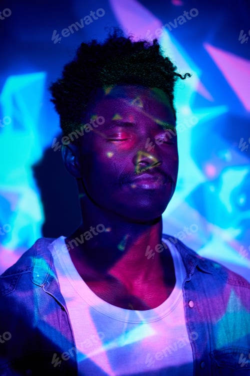 Vista previa: Calm black man standing with eyes closed in neon lights