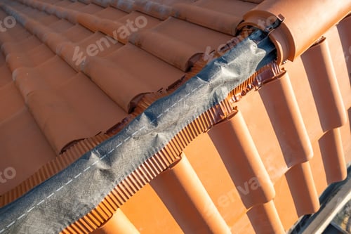Preview: Closeup of yellow ceramic roofing ridge tiles on top