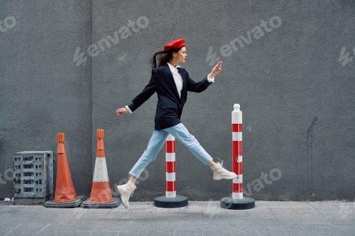 Preview: Fashion woman running down the street in front of the city tourist in stylish clothes with red lips