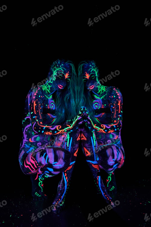 Preview: Art woman body art on the body dancing in ultraviolet light. Bright abstract drawings