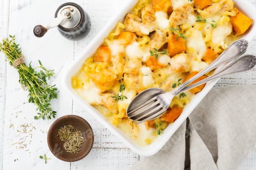 Preview: Casserole from chicken meat, pumpkin, pasta ,thyme, cheese and bechamel sauce in ceramic form on lig