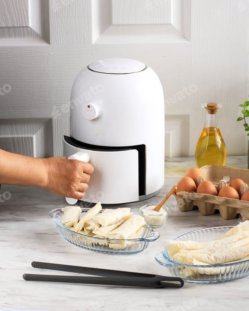 Preview: Cooking Process Using White Mini Air Fryer in the Kitchen.