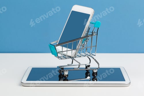 Preview: Smartphone with shopping cart on white background