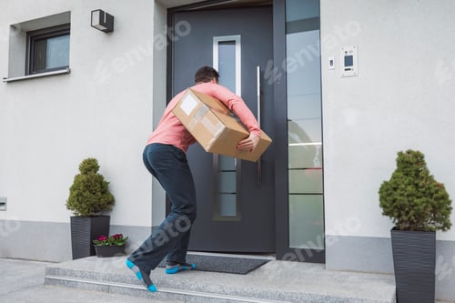 Preview: Adult excited man carrying a package ordered from online shopping. Very happy smiling person excited