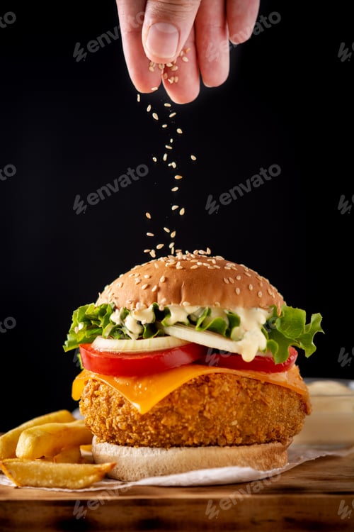 Preview: Pouring sesame seeds on crispy chicken burger