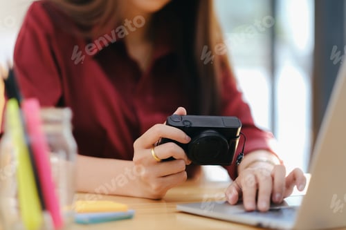 Preview: Photo artist and graphic desginer selecting pictures from camera.