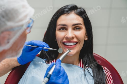 Preview: Orthodontist applying veneers, whitening her teeth, filling tooth, curing caries decay. Stomatology