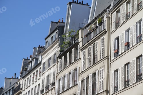 Preview: Historic Parisian apartment buildings with white shutters.