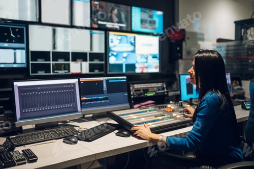 Preview: Middle aged woman using equipment in control room on a tv station