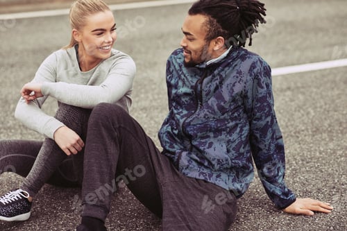 Preview: Smiling young couple taking a break from running