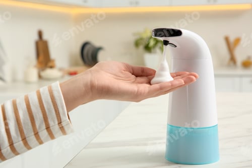 Preview: Woman using automatic soap dispenser in kitchen, closeup