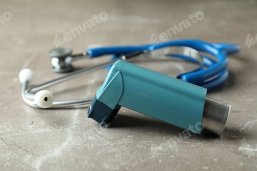 Preview: Asthma inhaler and stethoscope on gray textured table
