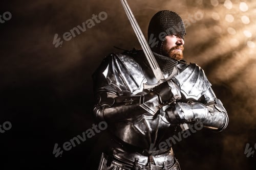 Preview: handsome knight in armor holding sword on black background