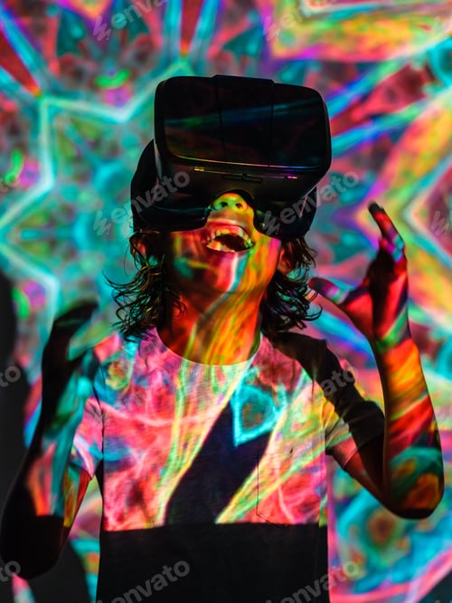 Preview: Cheerful boy in VR headset in neon lights