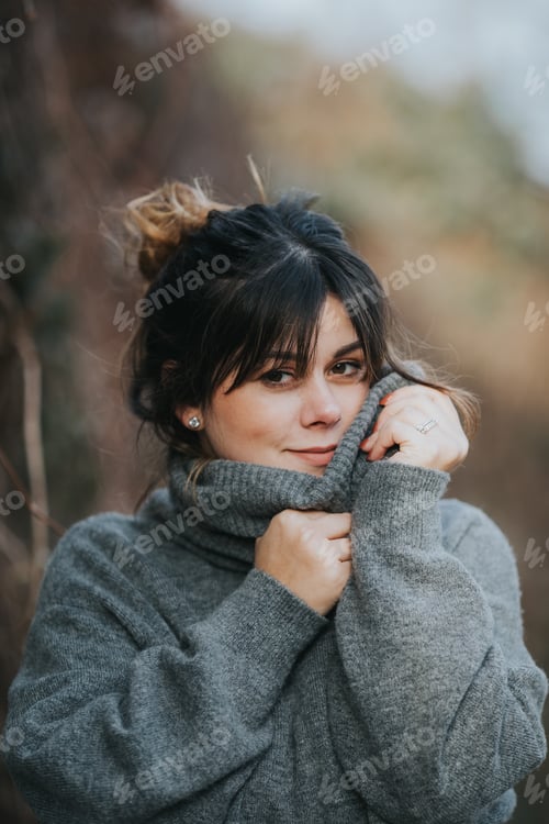 Preview: Woman in Grey Sweater Embraces Cold Weather