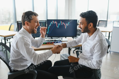 Preview: Two men traders sitting at desk at office together monitoring stocks data