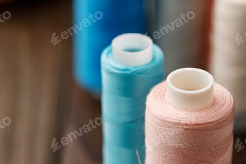 Preview: Close up of colored thread coils, thread spools background
