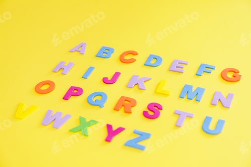 Preview: Back to school concept. Alphabet. Colourful letters on yellow background.