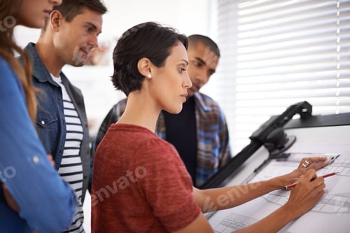 Preview: Shot of a group of young designers working together in an office