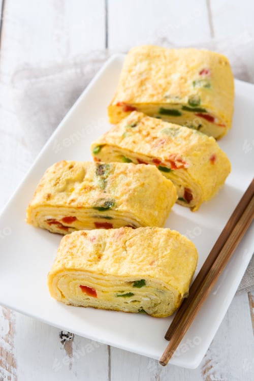 Preview: Tamagoyaki, japanese rolled omelette with vegetables, sliced and served