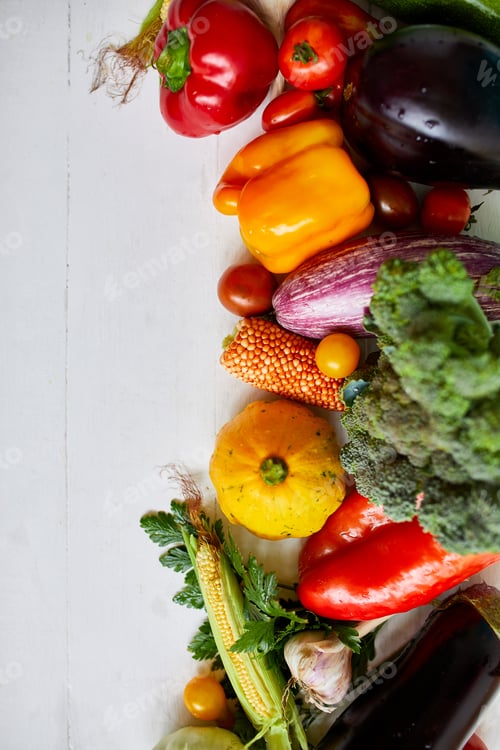 Preview: Top view assorted fresh organic vegetables on table in the kitchen