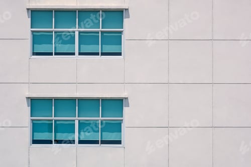 Preview: Architecture background of glass windows on large square concrete tiles wall of office building