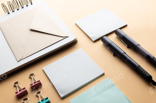 Preview: Flat lay of black pens, envelope, paper clips and memo notes with copy space on yellow background